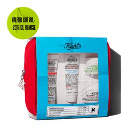 Kiehl's travel-sized skincare gift set in a red pouch, featuring multiple products visible through a blue-themed window.