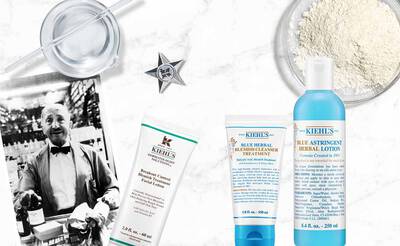 Ein Kiehl's Produktarrangement mit einem alten Foto, das einen Mann und verschiedene Hautpflegeprodukte zeigt.