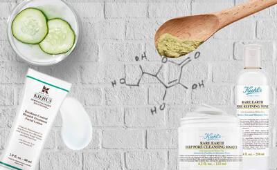 Produkte von Kiehl's: Gesichtscreme, Reinigungsmaske und Gesichtswasser, umgeben von Gurkenscheiben und einer chemischen Struktur.