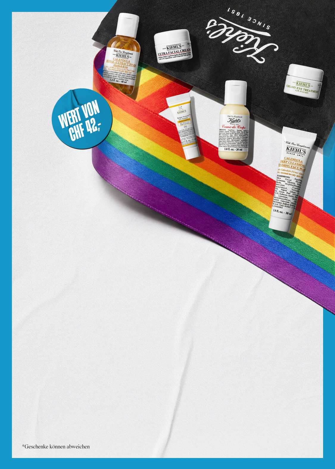 Kiehl's Pride-Set mit Miniaturprodukten im Wert von CHF 42,-, darunter Ultra Facial Cream, Calendula Herbal-Extract Toner, Creme de Corps und Calendula Deep Cleansing Face Wash, dekoriert mit einem Regenbogenband auf einer Kiehl's Tasche
