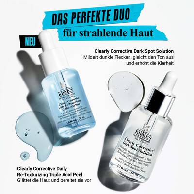 Alt-Text: Zwei Flaschchen von Kiehl's Hautpflegeprodukten auf einem hellen Hintergrund. Eines ist die "Clearly Corrective Dark Spot Solution" und das andere die "Clearly Corrective Daily Re-Texturizing Triple Acid Peel". Wassertropfchen sind rund um die Flaschchen verteilt.