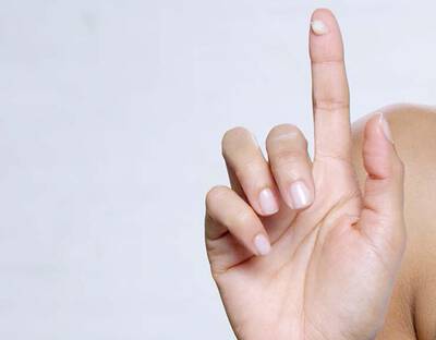 Hand mit Sonnencreme auf dem Zeigefinger