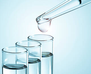 Retinol wird mit Pipette in ein Reagenzglas getropft