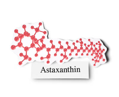 Illustration of the molecular structure of astaxanthin, a reddish pigment, accompanied by the label "Astaxanthin."