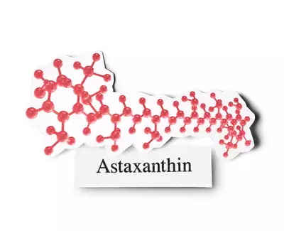 Illustration of the molecular structure of astaxanthin, a reddish pigment, accompanied by the label "Astaxanthin."