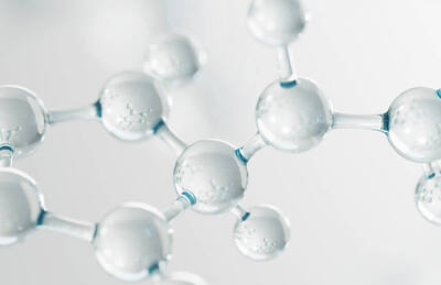 Close-up of a molecular structure, featuring transparent spheres connected by thin lines, resembling atoms and bonds in a scientific context.