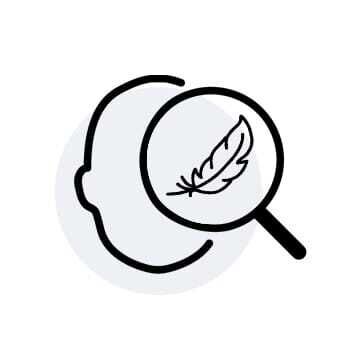 An outline of a face with a magnifying glass focusing on a feather.