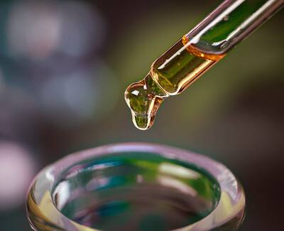 Close-up of a variety of roasted coffee beans, showcasing different shapes and shades of brown.