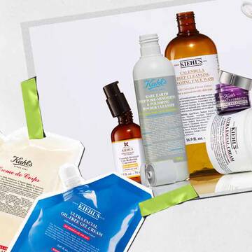 Une collection de produits de soin Kiehl's, notamment des lotions et des serums, disposes artistiquement avec des emballages et des etiquettes visibles et eclatants.