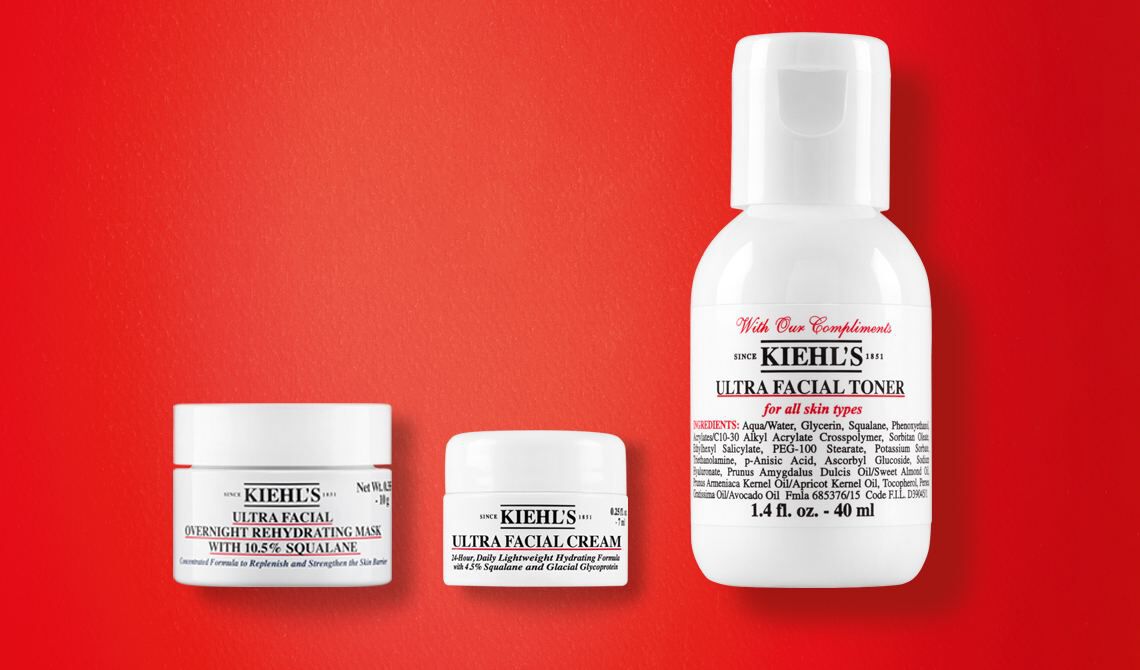 Trio de mini-produits Kiehl's sur fond rouge : Ultra Facial Overnight Rehydrating Mask avec 10,5% Squalane, Ultra Facial Cream et Ultra Facial Toner pour tous types de peau