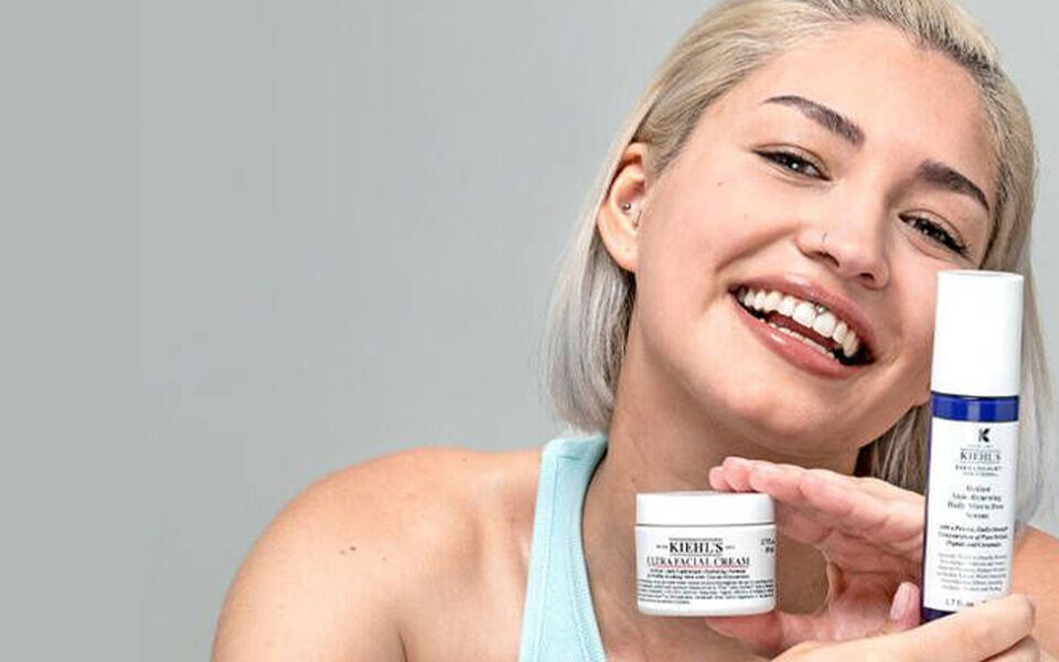 A simple, minimalist design featuring a small green leaf shape on the left side against a plain white background.