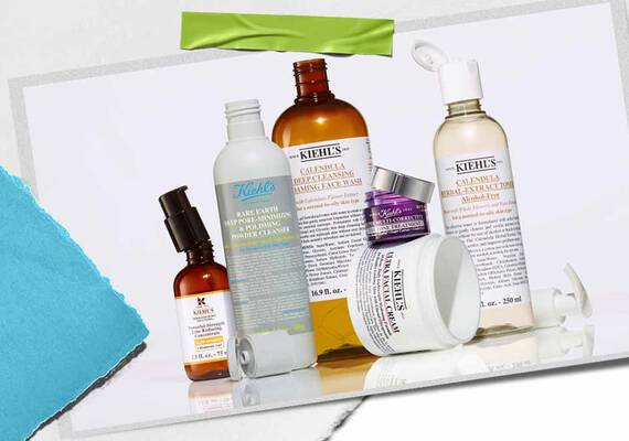Une collection de produits de soin Kiehl's, notamment des lotions et des serums, disposes artistiquement avec des emballages et des etiquettes visibles et eclatants.